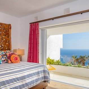 Bedroom suite with terrace access and ocean views