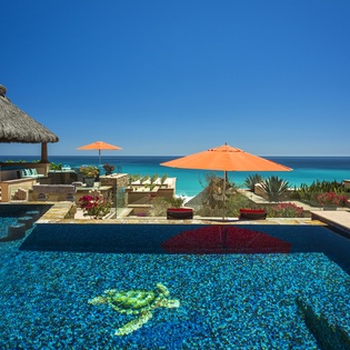 Stunning oceanfront infinity pool with crystal-clear waters overlooking pristine turquoise Caribbean seas and tropical paradise surroundings.