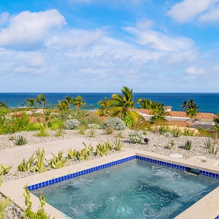 Your private oasis features a sparkling pool framed by lush desert landscaping, with the Sea of Cortez stretching endlessly beyond. Perfect for soaking up the warm breeze and coastal views.