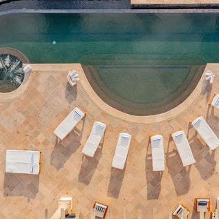 Aerial view of patio with jacuzzi and infinity pool