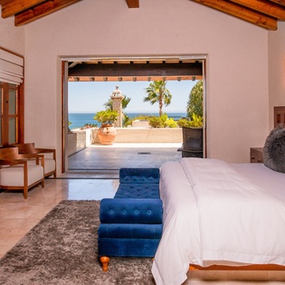 Bedroom suite with patio access and ocean views
