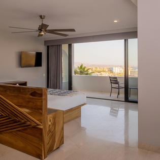 Bedroom suite with patio access and ocean views