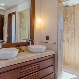 En suite bathroom with double sink and walk in shower