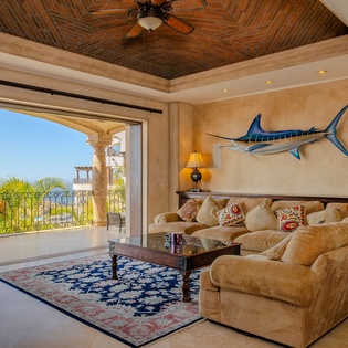 Relax in your elegant living space with stunning ocean views and tropical breezes flowing through open doors.