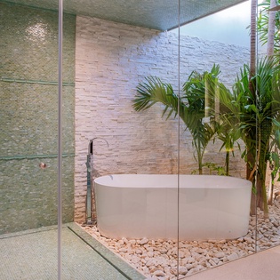 Tropical en suite bathroom with bathtub and walk in shower