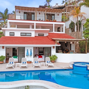 Modern beachside villa with private pool, hot tub, and multiple terraces overlooking tropical surroundings.