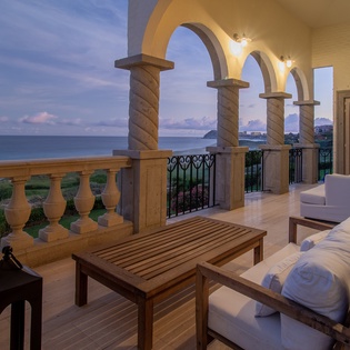 Balcony seating with ocean views during sunset