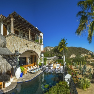Stunning Mexican villa with private pool, tropical palapa, and mountain backdrop creates your perfect desert oasis retreat.
