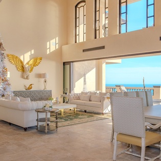 Spacious bright living area with access to ocean view patio