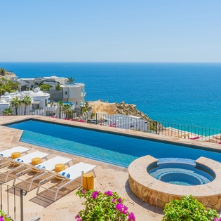 Breathtaking infinity pool overlooking crystal-clear waters, perfect for soaking up sun while enjoying panoramic ocean views.