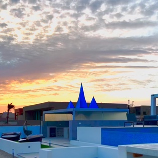 Exterior view of villa during sunset