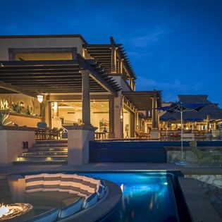 Stunning beachfront villa with infinity pool, fire pit, and thatched palapa creating the perfect tropical escape.