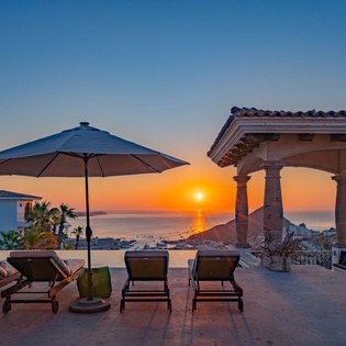 Spectacular sunset terrace with ocean views and elegant outdoor seating creates the perfect evening retreat.