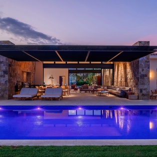 Poolside view of exterior during sunset