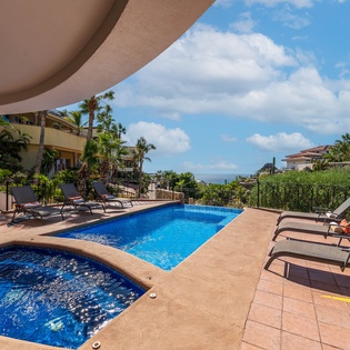 Sunny patio with jacuzzi and ocean view