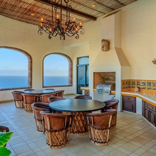 Stunning ocean views frame your private outdoor kitchen and dining terrace, perfect for sunset dinners and morning coffee with endless blue horizons stretching before you.