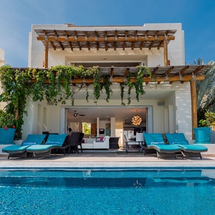 Poolside view of beautiful exterior