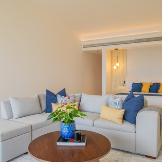 Sink into plush seating while enjoying your private bedroom's warm ambiance and thoughtful design details.