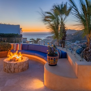 Unwind by your private fire pit as the sun sets over the ocean, creating the perfect evening retreat with panoramic coastal views.