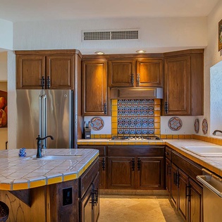 Your fully equipped kitchen features warm wood cabinetry, vibrant tile accents, and modern appliances—perfect for preparing home-cooked meals during your stay.