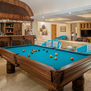 Your perfect game room retreat features a stunning pool table, full bar, and cozy seating for endless entertainment.