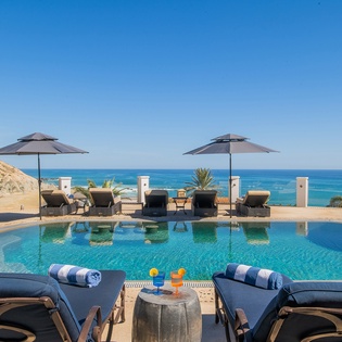 Sunny poolside patio overlooking an incredible ocean view