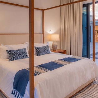 Step into your serene sanctuary, where natural wood tones and crisp linens create a calming retreat. Open the doors to your private terrace and let the gentle light invite you to unwind in style.