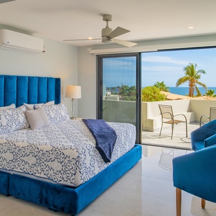Wake up to stunning ocean views from your comfortable bedroom with modern amenities and private balcony access.