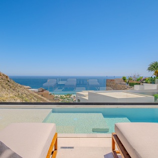 Unwind by the infinity pool with breathtaking ocean views and luxurious loungers for perfect poolside relaxation.