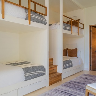 Your family will love these cozy bunk beds with built-in storage and warm wood accents creating the perfect sleep sanctuary.