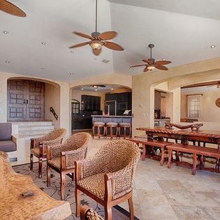 Gather around handcrafted wooden tables and sink into comfortable woven chairs in this breezy, open living and dining space—your home base for meals, conversation, and relaxation.