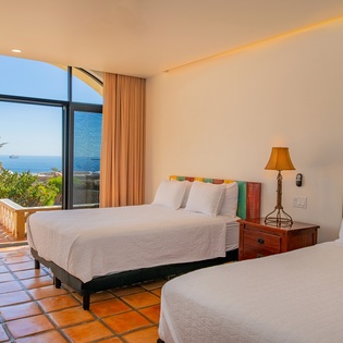 Bedroom suite with 2 queen beds and incredible ocean views and outdoor access