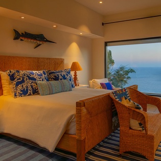 Wake up to endless ocean views in your coastal sanctuary, where warm nautical touches and panoramic windows frame the perfect morning.