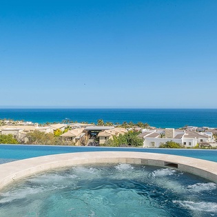 Soak in the bubbling hot tub while gazing at stunning ocean views stretching to the horizon. A perfect spot to unwind after a day of exploring the coastline.