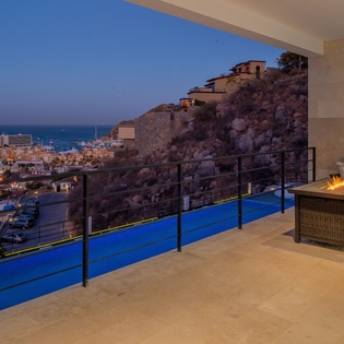 Terrace with city and ocean view at night