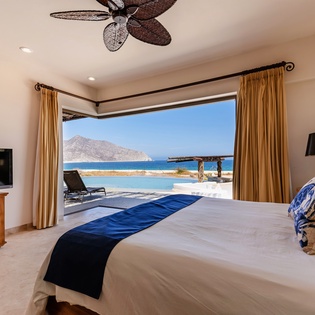 Bedroom suite with patio access and ocean views