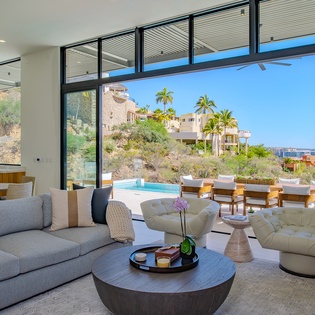 Spacious living area with access to patio and ocean views