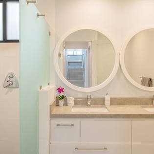 Refresh in your elegant ensuite with dual vanities, walk-in shower, and charming orchid touches brightening your morning routine.