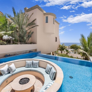 Poolside with firepit and ocean views