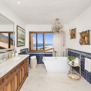 En suite bathroom with bathtub and ocean views