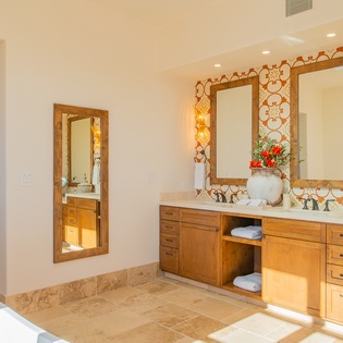 Unwind in your spa-inspired master bathroom with dual vanities, soaking tub, and stunning decorative tilework that creates a luxurious retreat.