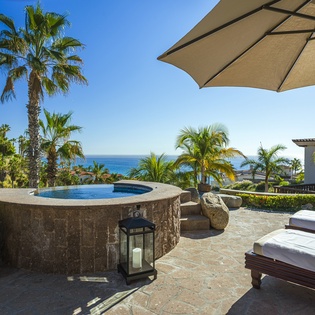 Sunny patio with jacuzzi and ocean views