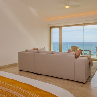 Bedroom suite with seating area and ocean views
