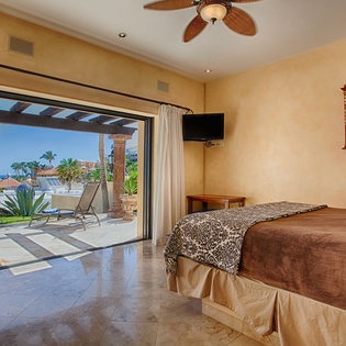 Your serene bedroom opens directly to a private terrace, where ocean breezes and stunning coastal views greet you each morning through expansive glass doors.