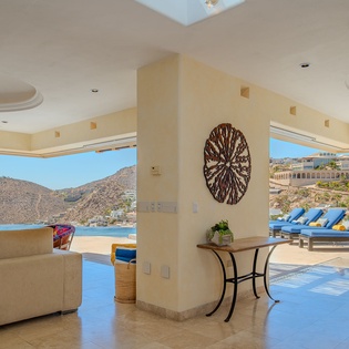 Relax in your elegant covered terrace with stunning poolside views and comfortable seating overlooking the sparkling blue waters.