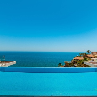 Infinity edge pool with lounge chairs