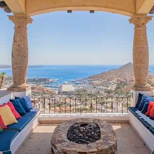 Stunning sea views from this elegant terrace with comfortable seating and traditional stonework overlooking the coastal landscape.