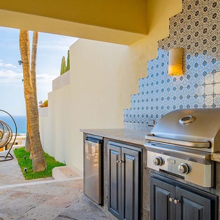 Your outdoor kitchen is ready for grilling and entertaining, with stunning ocean views as your backdrop. Gather here for unforgettable meals under the sun.