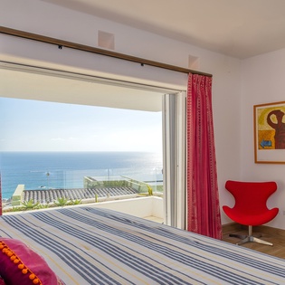 Bedroom suite with terrace access and ocean views