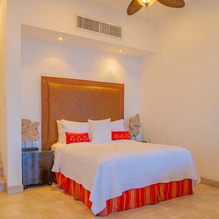 Sink into crisp white linens and tropical-inspired décor after a day of adventure. Your serene retreat features a woven headboard, climate control, and a stylish ceiling fan.